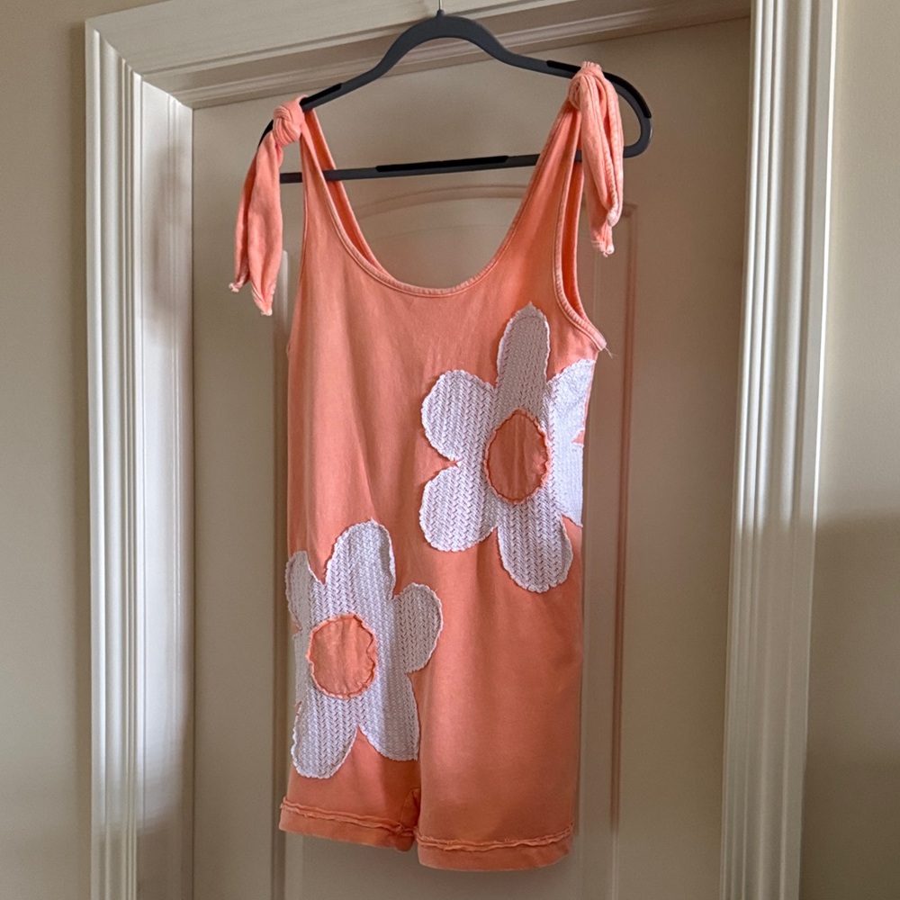 Orange Romper with White Floral Design